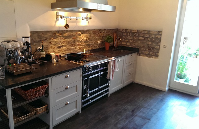 Eine Küche aus unechtem Mauerwerk wird zuerst bei der herstellenden Firma bearbeitet